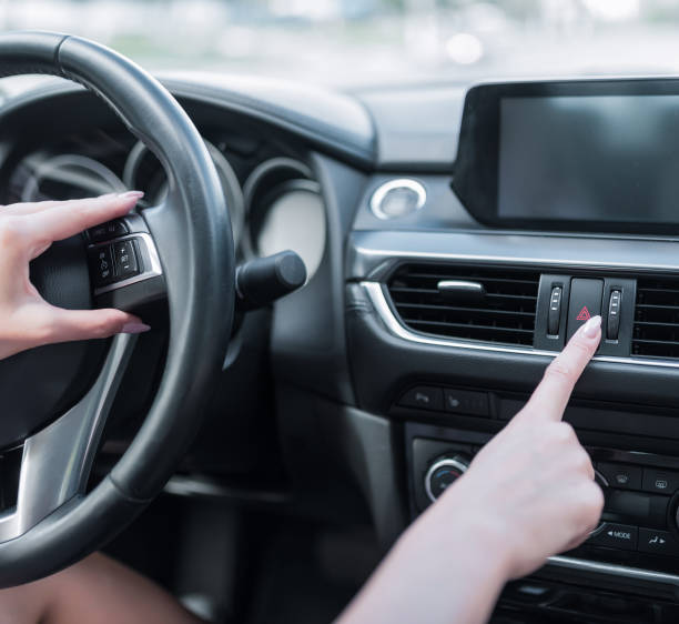 istock Close-up woman s finger, includes emergency stop button, alarm, problem and accident,calling signal of dimensions, activating safety on road. Car interior, touch screen display. 1177318077