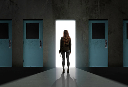 Woman standing in front of open door