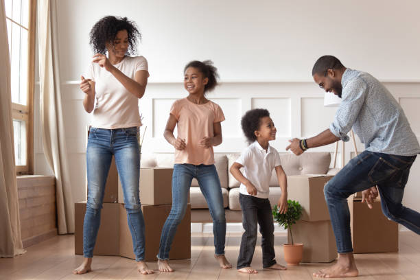 African couple kids celebrating relocation day dancing feels happy