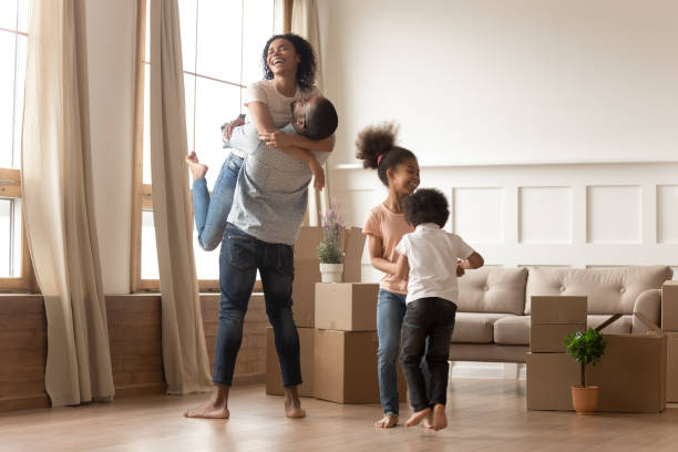 istock Mixed-race family fooling around having fun celebrating relocation day 1177320032