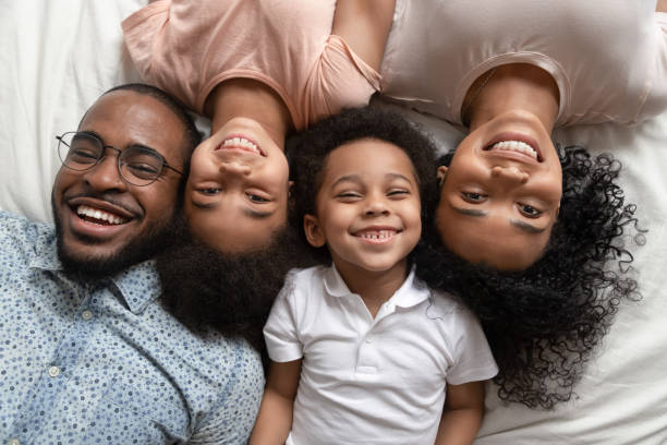istock Happy african full family lying smiling looking at camera 1177320078