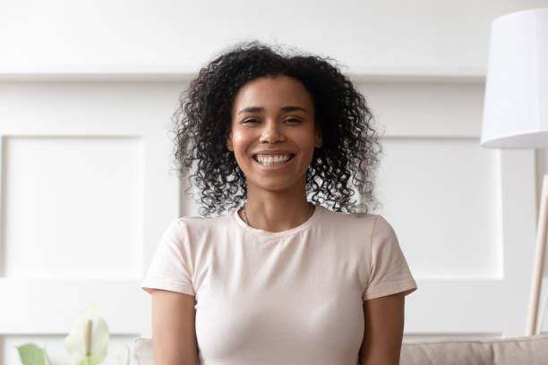 istock Cheerful african woman sit on couch look at camera 1177320111