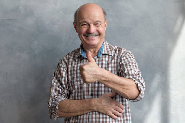 istock cheerful middle aged man giving thumb up on white background 1177321362