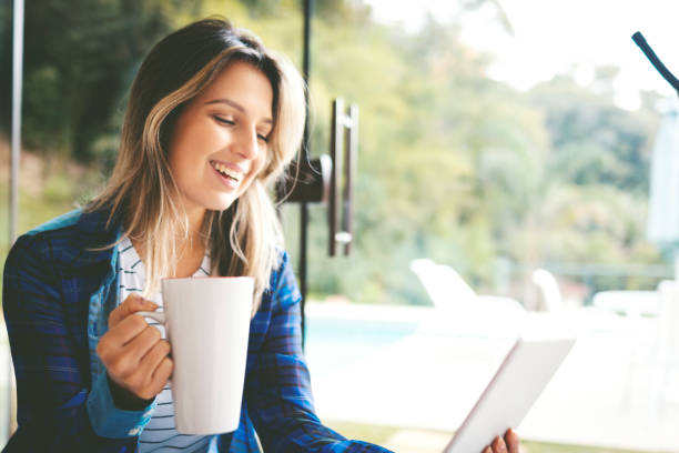 istock Portrait of a beautiful woman using digital tablet and drinking coffee 1177323642