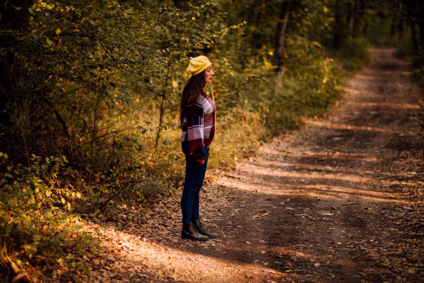 istock Woman Walking on The Forest Autumn Road 1177323783