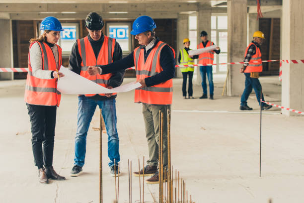 istock Building contractors and architect examining plans 1177326257