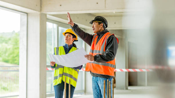 istock Construction foreman explaining details to investor while they hold a blueprint 1177326299