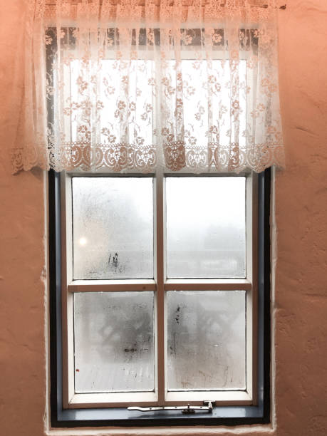 orange mug in blue scarf on window background