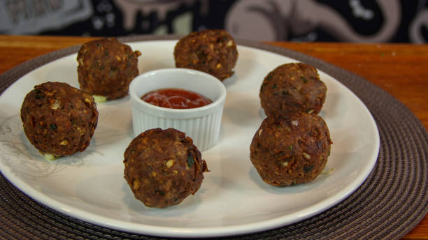 istock Big fried meatballs served with ketchup sauce on a plate 1177328389