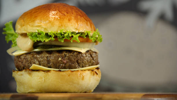 istock Homemade burger with cheese and salad bokeh background 1177330244