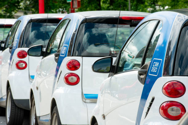 In Vancouver, Canada many Smart Cars with Car2Go branding are parked alongside a downtown street.