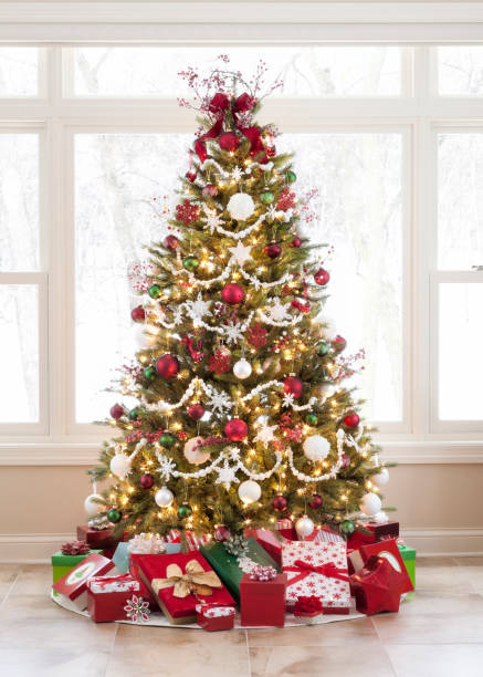 christmas tree with ornaments and gifts against a picture window - window snow christmas decoration imagens e fotografias de stock