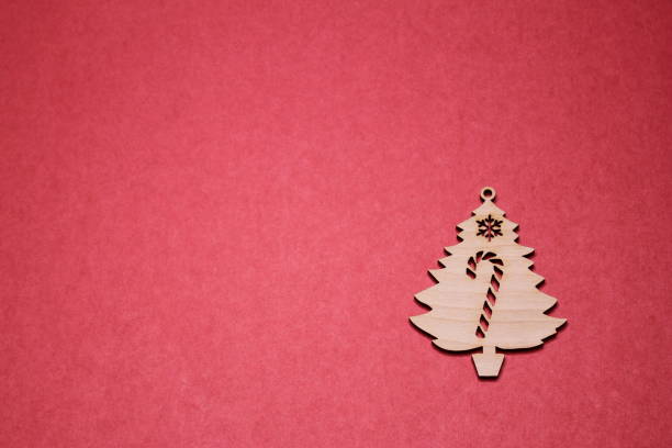istock Wooden Christmas tree figurine on a red background. Copy space. 1177333039