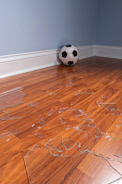istock Broken glass from a window pane on the floor with soccer ball 1177333047