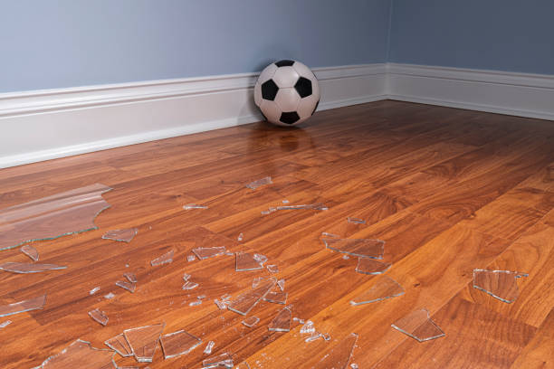 istock Broken glass from a window pane on the floor with soccer ball 1177333053