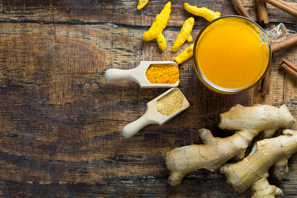 istock Herbal ginger and turmeric tea in glass cup with ginger root, dry turmeric, cinnamon sticks and their powder 1177333732