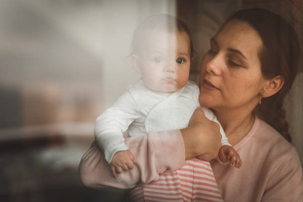 istock Baby girl looking at camera through the window 1177334756