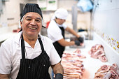 Portrait of a butcher in butchers shop