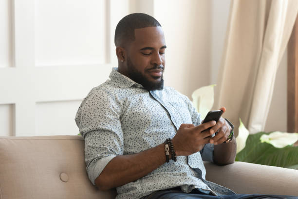 istock Happy positive black man doing purchases on internet websites. 1177334828
