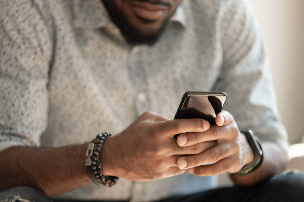 istock Close up young african american man holding smartphone. 1177334833
