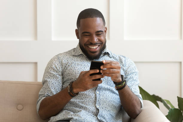 istock Addicted happy smiling african american guy using mobile phone. 1177334845