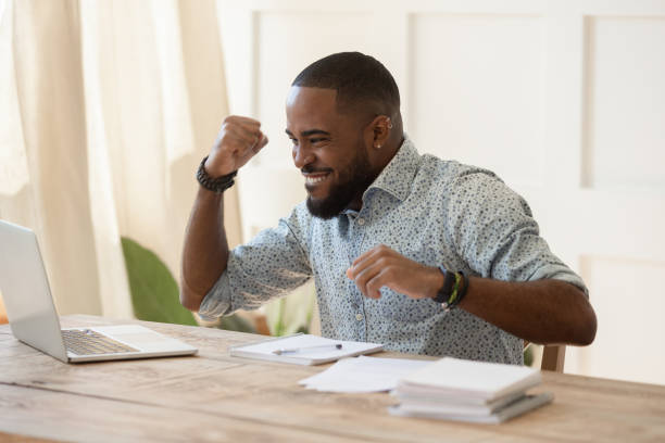 istock Euphoric young black man celebrating online lottery win. 1177334862