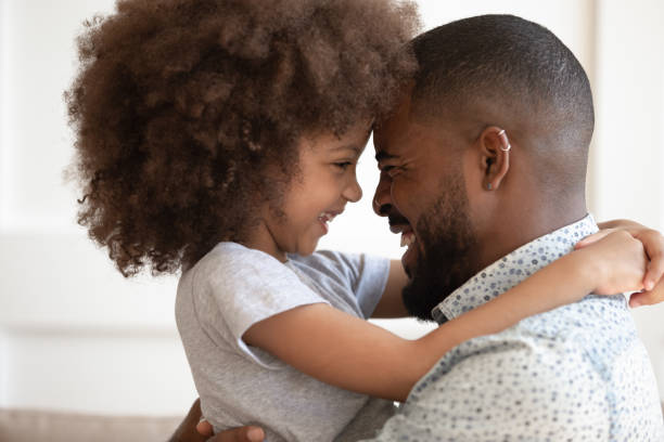 istock Close up head shot happy little daughter hugging dad. 1177334893