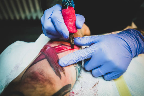 istock Tattoo artist coloring a tattoo 1177335025