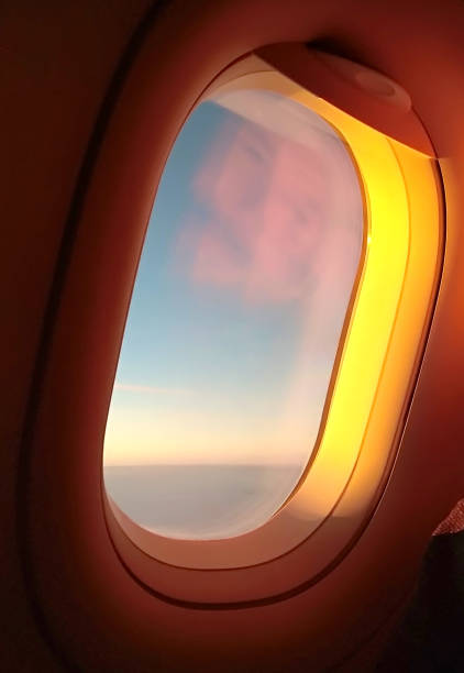 istock Airplane porthole lit orange sunlight 1177336350