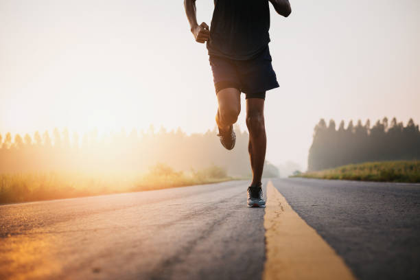 istock Athlete runner feet running on road, Jogging concept at outdoors. Man running for exercise. 1177338018