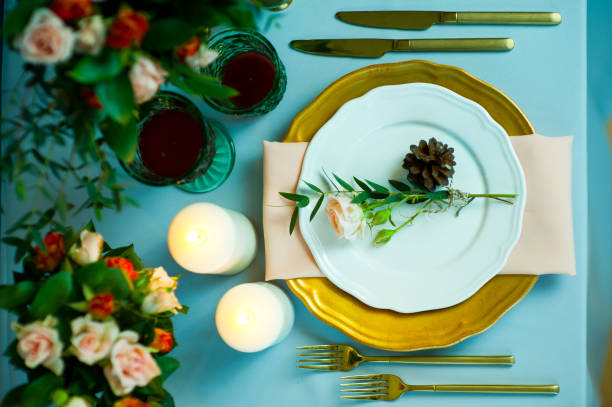 istock turquoise-colored table with gold plates and cutlery. top view 1177341899