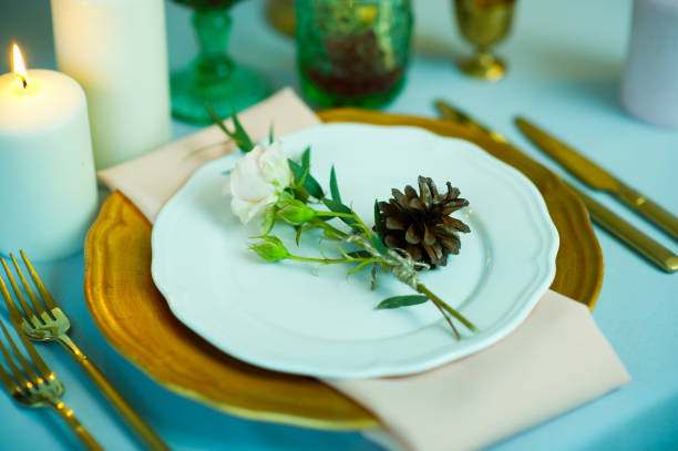 istock turquoise-colored table with gold plates and cutlery. top view 1177341900