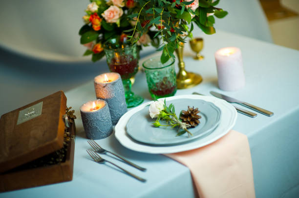 istock turquoise-colored table with gold plates and cutlery. top view 1177341908