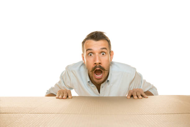 istock Young man opening the biggest postal package isolated on white 1177342466