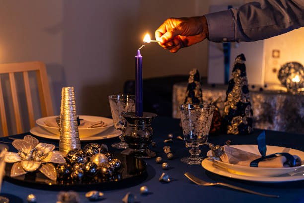 istock A man's hand lighting the candle of a Christmas table 1177344925
