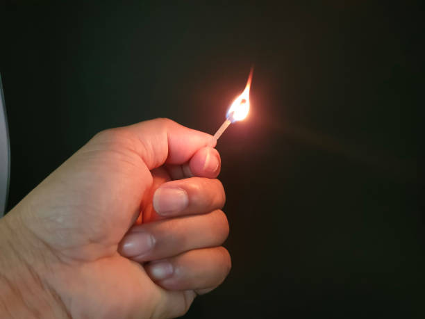 istock Closed up burning match with my hand in the dark 1177345008