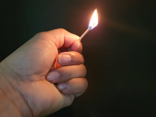 istock Closed up burning match with my hand in the dark 1177345010
