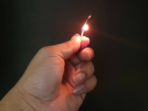 istock Closed up burning match with my hand in the dark 1177345012