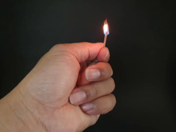 istock Closed up burning match with my hand in the dark 1177345016