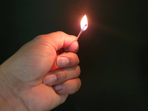 istock Closed up burning match with my hand in the dark 1177345019