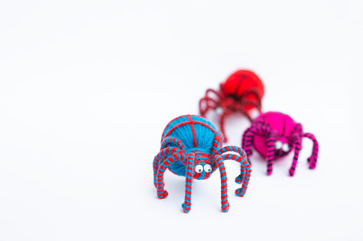 Colourful yarn spider isolate on white background, Halloween decorate item