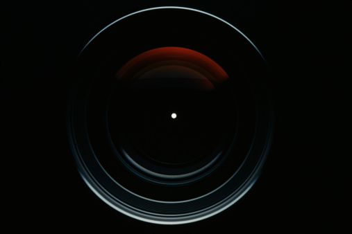 Isolated shot of professional camera lens against black background