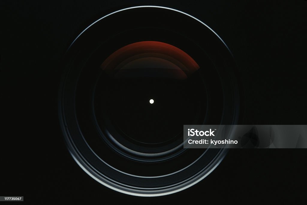 Isolated shot of professional camera lens against black background Close-up of a professional camera lens against black background. Lens - Optical Instrument Stock Photo