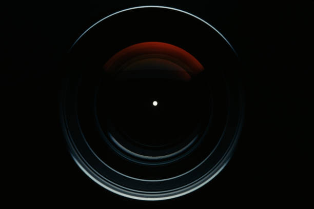 Isolated shot of professional camera lens against black background Close-up of a professional camera lens against black background. aperture stock pictures, royalty-free photos & images