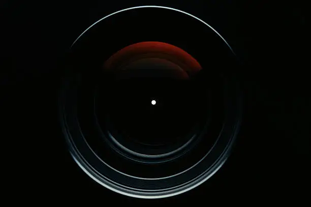 Photo of Isolated shot of professional camera lens against black background