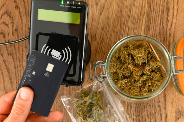 Purchasing legal marijuana at a dispensary Paying by credit card for marijuana at a cannabis dispensary. Purchasing legal recreation drugs. Medical marijuana at a clinic. cannabis store photos stock pictures, royalty-free photos & images