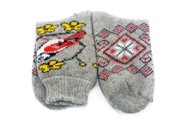 istock Warm gray socks made of natural wool with a winter pattern on an isolated background 1177356519