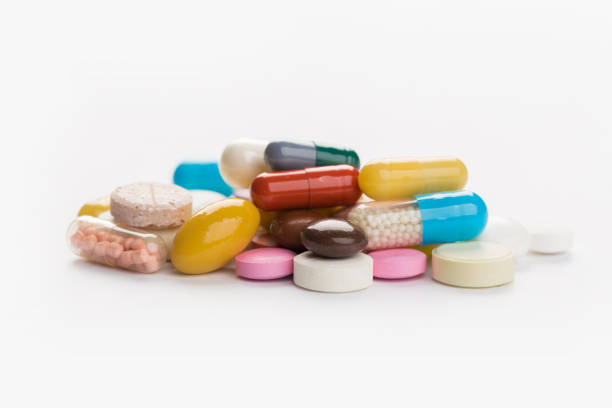 istock Assorted pharmaceutical medicine pills, tablets and capsules.Heap of assorted various medicine tablets and pills different colors on white background. 1177359877