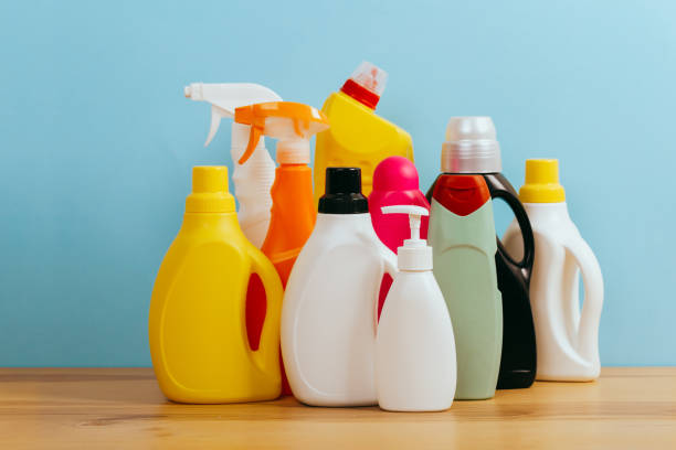 istock Cleaning product plastic container for house clean on wooden table and blue background . 
