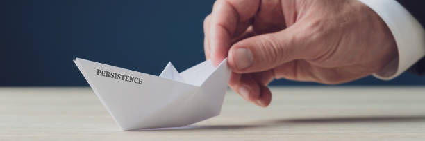 istock Paper made origami boat with Persistence sign 1177359926